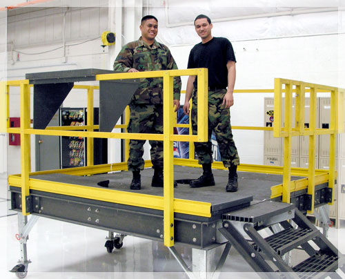 Air Force employees on engine maintenance platform