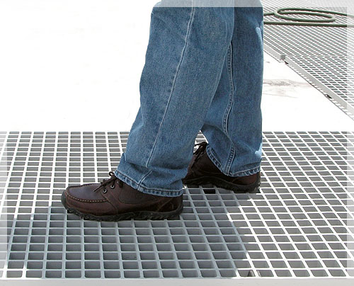 man walking on grey square mesh walkway