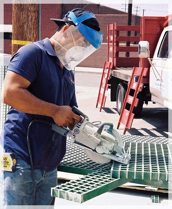 Man cutting green fiberglass mesh molding